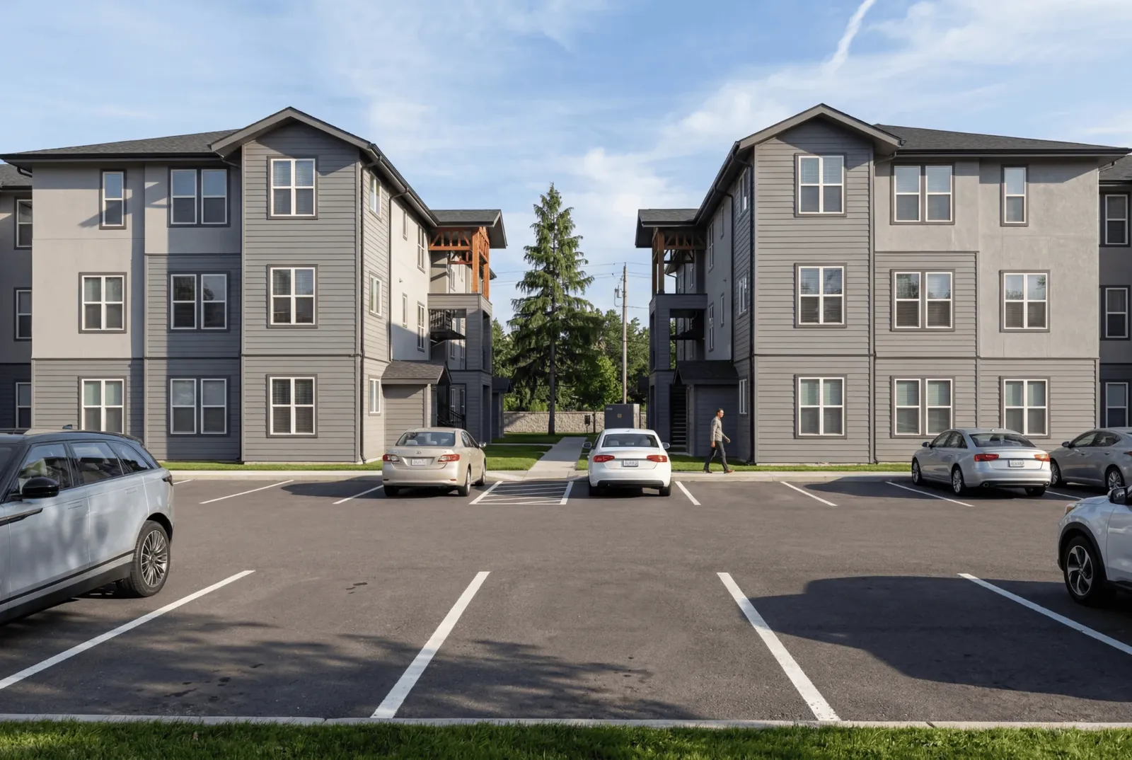Rendering: Two apartment buildings facing each other across parking, with a walkway between them