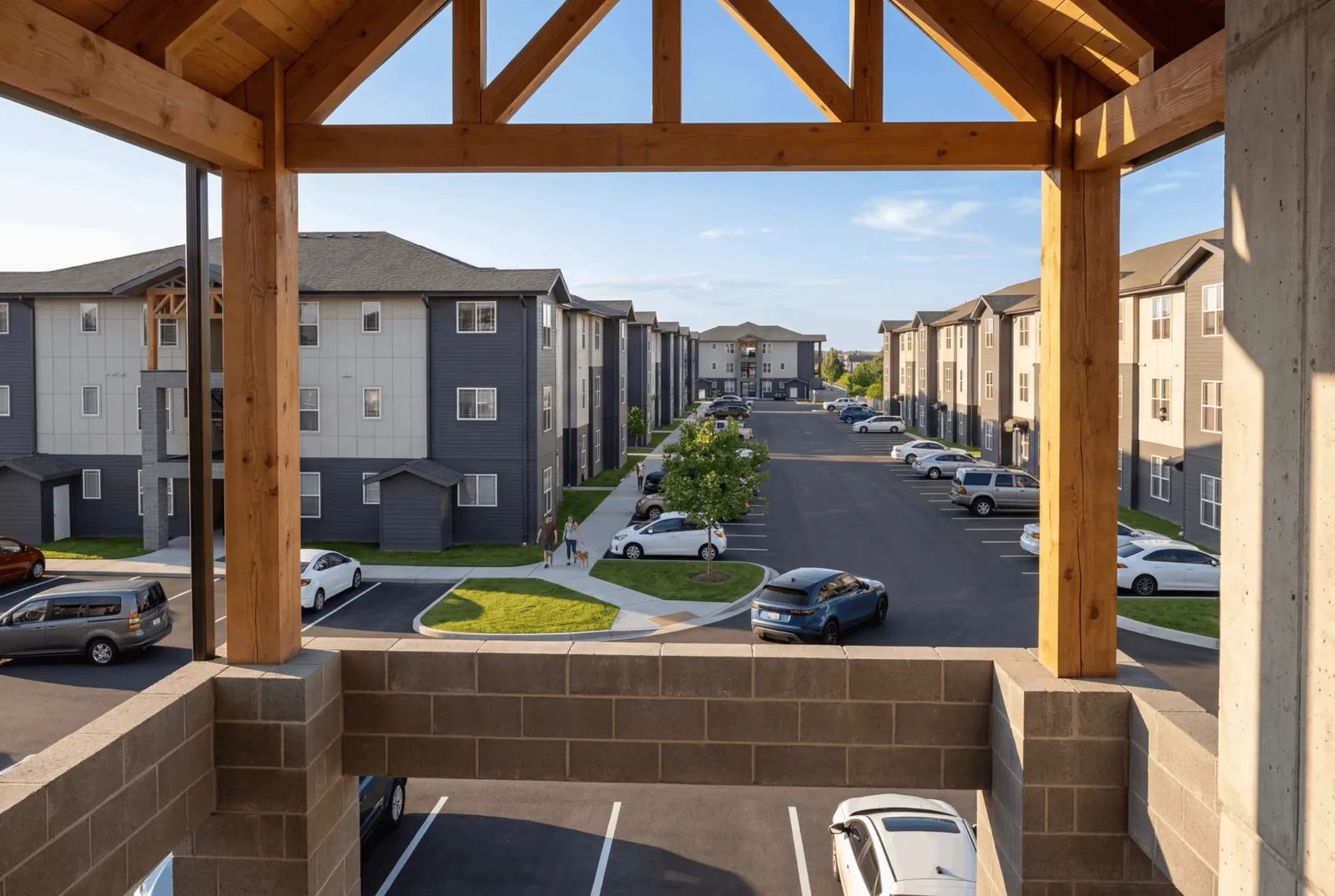 Rendering: View from a timber-framed stair landing down the main drive between apartment buildings